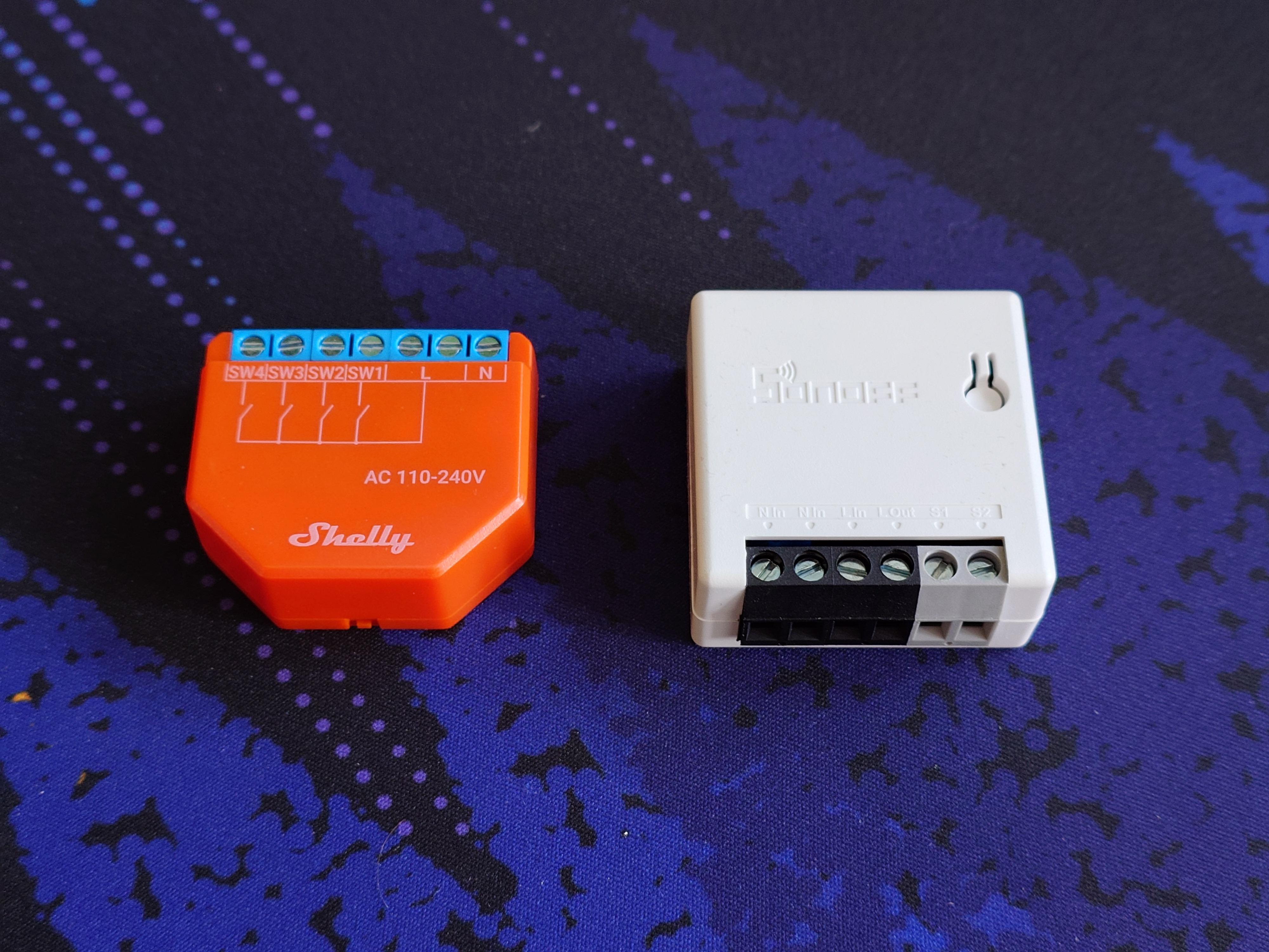 An image of two smart switches next to each other, the left one in a Shelly I4, and the right one is a Sonoff MINI R2